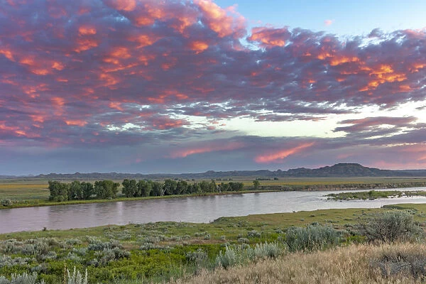 Sunrise and clouds over the Yellowstone River at the confluence with the Powder River near Terry