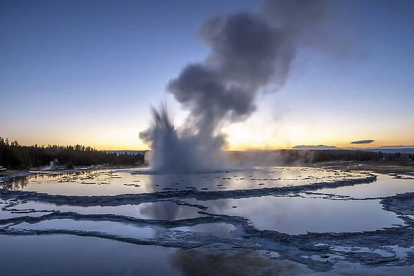 Sunset over active geyser. Fire Hole. Yellowstone National Park. Wyoming