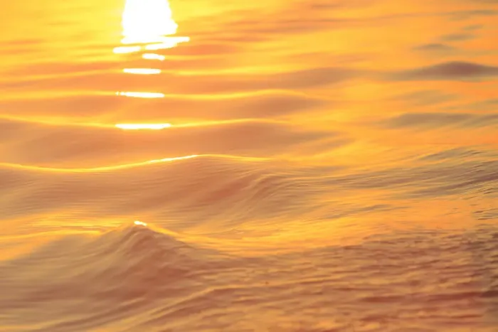 Framed Print : Sunset colors and patterns on small waves in water