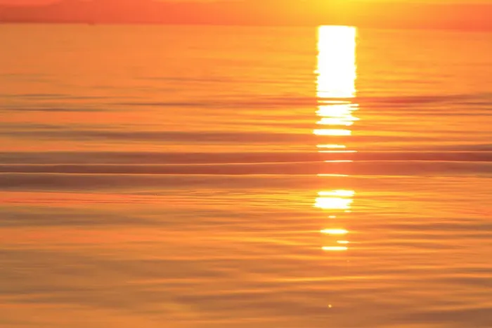 Framed Print : Sunset colors and patterns on small waves in water