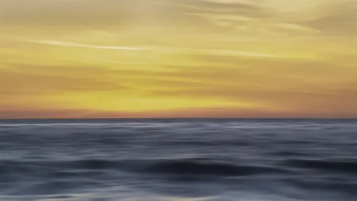 Framed Print : Sunset colors in the sky over the smooth ripples of the ocean
