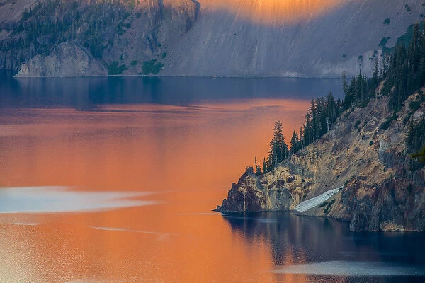 Sunset colors the waters at Crater Lake National Park, Oregon, USA