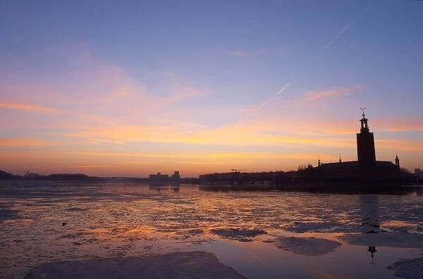 Sunset over an ice covered Riddarfjarden water towards the west with Kungsholmen