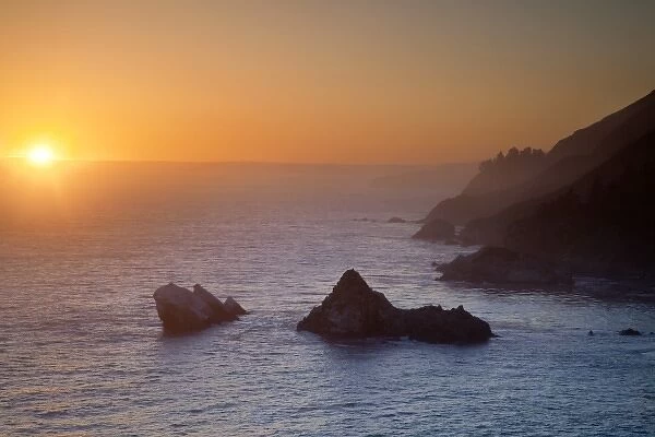 Sunset light on the cliffs over the Pacific Ocean at Julia Pfeiffer Burns State Park