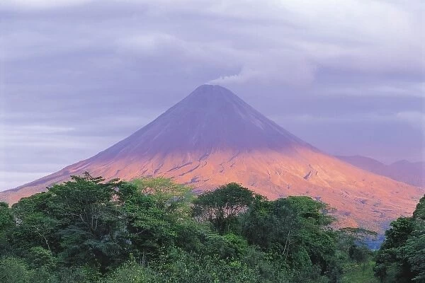Sunset light peers through the clouds to illuminate the flanks of Arenal Volcano (1