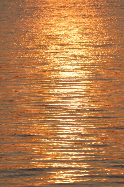 Sunset reflections on ripples of water