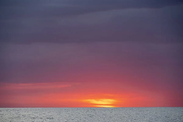 Sunset sky with clouds over ocean seen from La Boca, Cuba