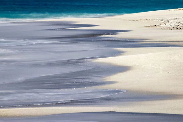 Surf pattern washing up on white sandy beach, Espanola Island, Galapagos Islands, Ecuador