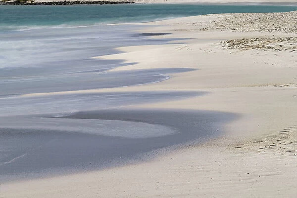 Surf pattern washing up on white sandy beach, Espanola Island, Galapagos Islands, Ecuador