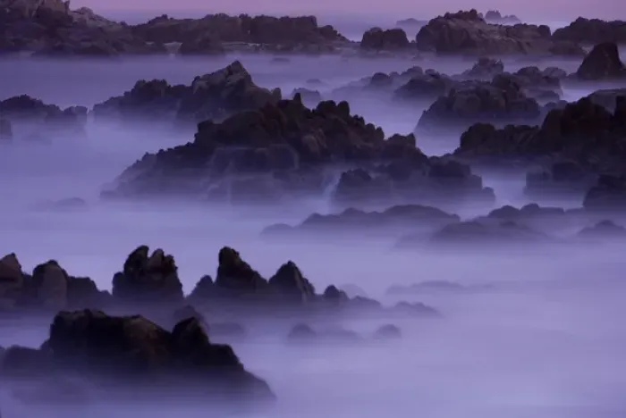 Framed Print : Surf pours over the California coastline at dusk