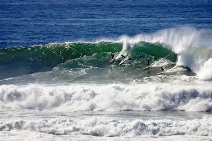 Framed Print : Four surfers catch a wave at the 2006 Mavericks big wave surf competition near Half