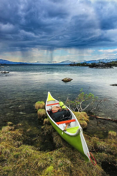 Sweden, Norrbotten, Abisko, Stordalen Nature Preserve. Canoe on shoreline of Torne Lake