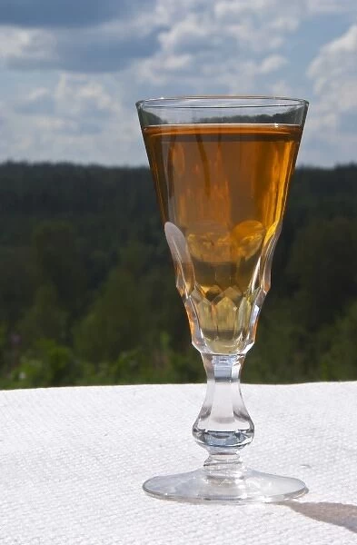 Swedish traditional aquavit schnapps glass in pointed form filled to the brim with spiced vodka