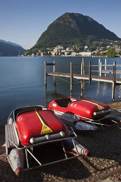 Switzerland, Ticino Canton, Lugano. Lakefront paddleboats and Monte San Salvador