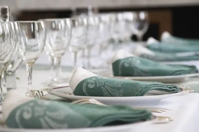 Framed Print : Table set in traditional style, white plates with golden decoration, white and green linen napkins