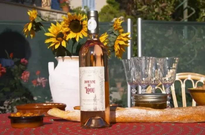 Framed Print : Table with wine aperitif and appetizers, bottle of Domaine Loou rose wine. Clos des