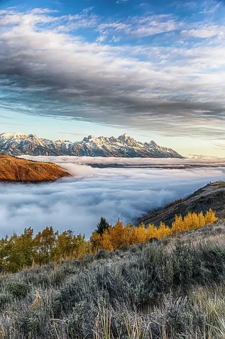 Framed Print : A temperature inversion cause a layer of fog to form in the valley below the peaks of Grand Teton National Park