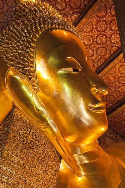Thailand, Bangkok. Close-up of the head of the Reclining Buddha inside Wat Pho