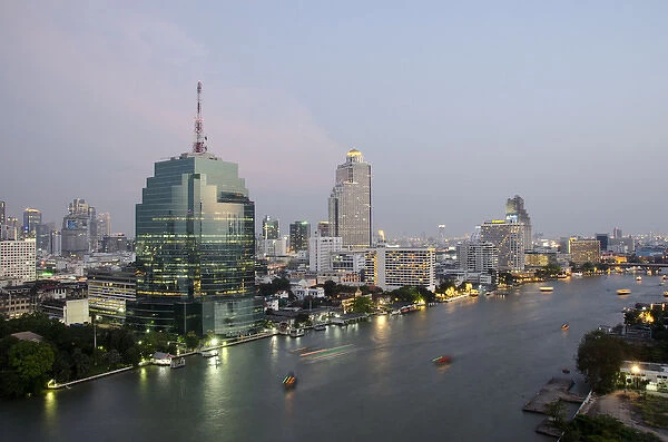 Thailand, Bangkok. Downtown Bangkok, evening skyline view of the Chao Phraya river