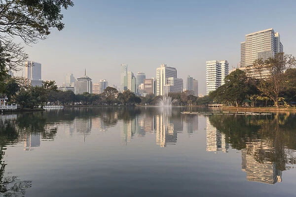 Thailand, Bangkok. Lumphini, Lumphini Park, city skyline at dawn