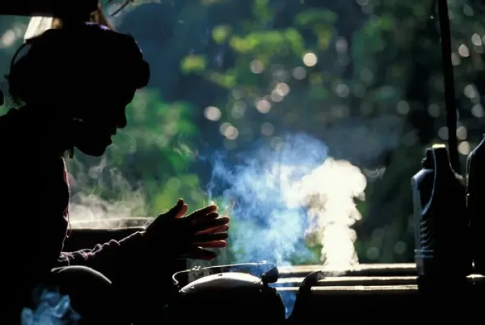 Framed Print : Thailand, Doi Inthanon National Park, Young woman sits by steaming tea kettle Framed Print : Thailand, Doi Inthanon National Park, Young woman sits by steaming tea kettle
