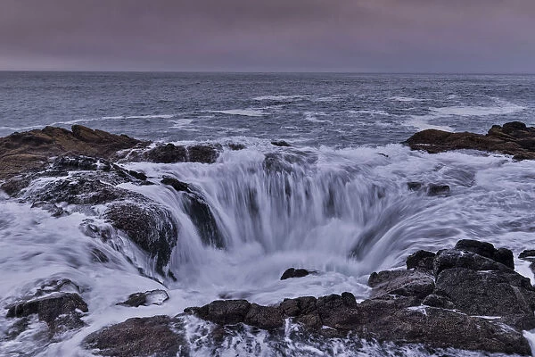 Thors Well with surf cascading into the well along the Oregon coastline