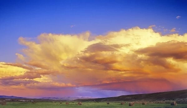 Thunderstorm over hay bales near Dillon, Montana
