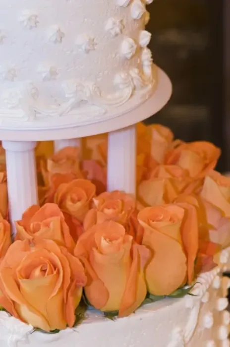 Framed Print : Detail of tiered wedding cake decorated with orange roses Framed Print : Detail of tiered wedding cake decorated with orange roses