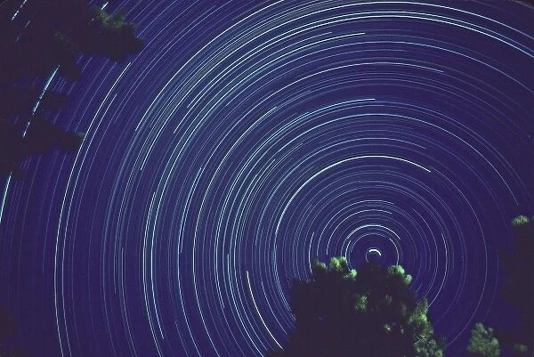 Time exposure centered on North Star night star tracks from earths rotation