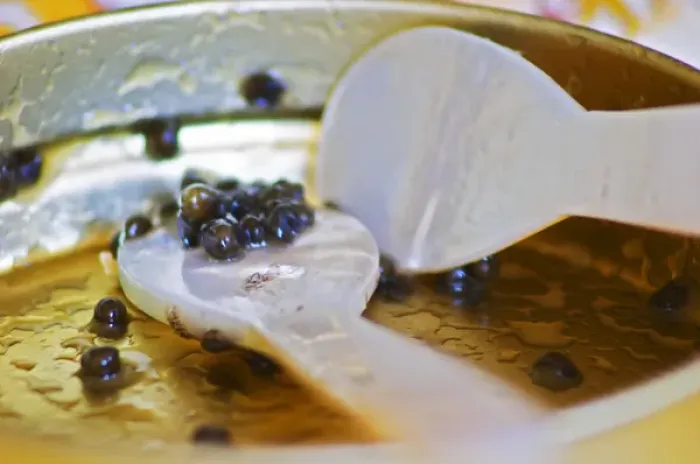 Framed Print : An empty tin of sturgeon caviar with two mother of pearl spoons and only a few grains