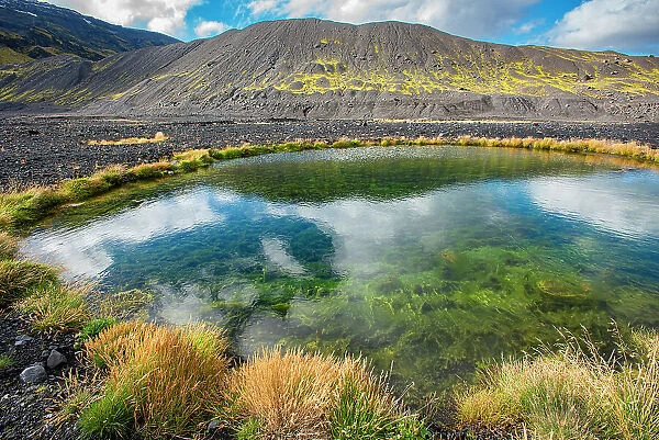 Tiny pond created by violent volcanic forces. The eruption of the Eyjafjallajokull volcano in 2010 caused much melting of the icecap that covered the volcano