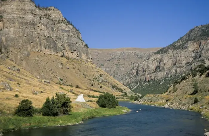 Framed Print : Tipi sits on the banks of the Wind River that winds through a steep walled canyon