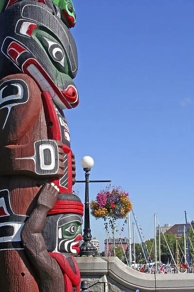Totem hanging floral baskets along waterfront Victoria British Columbia