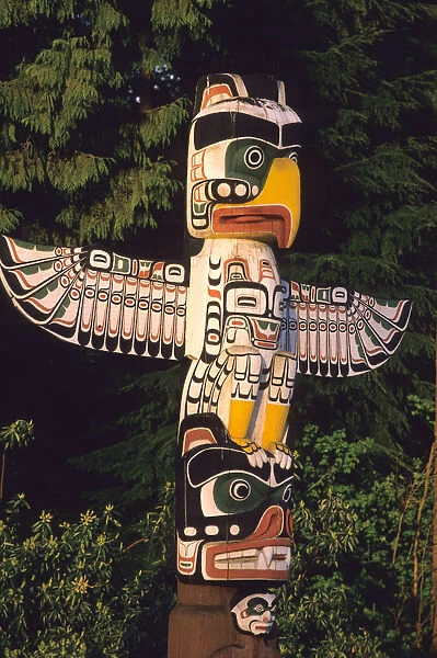 A totem pole In Vancouver, Canada. totem pole, eagle, bear, wood, carving