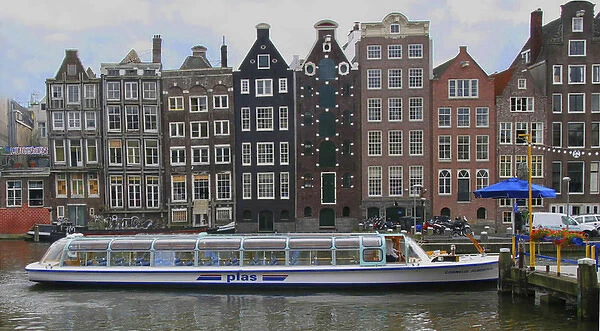 A tour boat waiting at Rederij Plas dock on a canal lined with colorful gabled homes