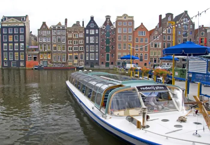Framed Print : A tour boat waiting at Rederij Plas dock on a canal lined with colorful gabled homes Framed Print : A tour boat waiting at Rederij Plas dock on a canal lined with colorful gabled homes