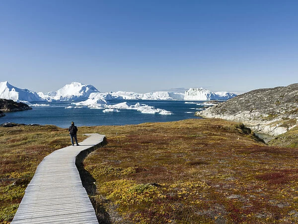 Tourists admiring the fjord. Ilulissat Icefjord also called kangia or Ilulissat Kangerlua