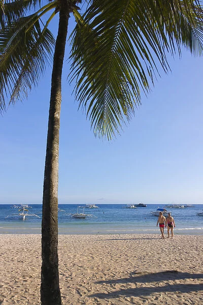 Tourists and palm tree on the beach, Bohol Island, Philippines