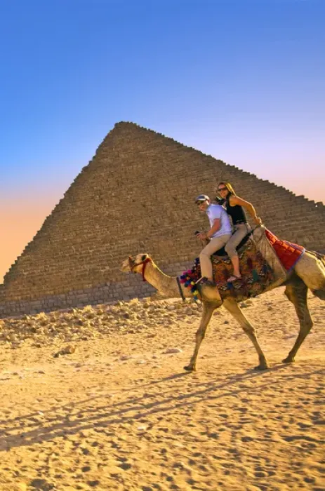 Framed Print : Tourists ride a camel in front of the Great Pyramids of Egypt in Cairo on the Giza Framed Print : Tourists ride a camel in front of the Great Pyramids of Egypt in Cairo on the Giza