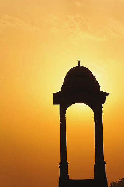 Tower near the India Gate silhouetted at sunset, New Delhi, India