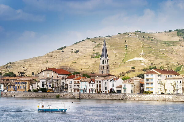 The town Tain l Hermitage, the riverside side, the river Rhone. A sailing boat on the water