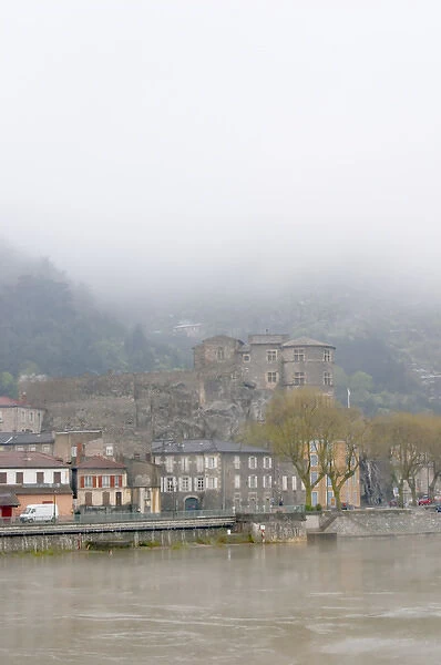 The town Tournon across the Rhone river with the Chateau de Tournon. under snow