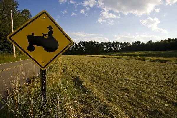 A tractor crossing sign next to a farm in Pepperell, Massachusetts