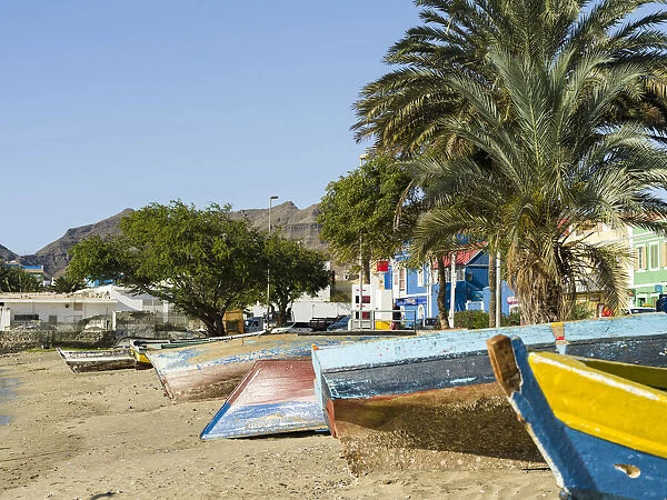 Traditional fishing boats on the beach of the harbor. City Mindelo