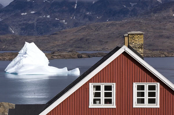 Traditional house and iceberg Tasiilaq (Ammassalik) Greenland