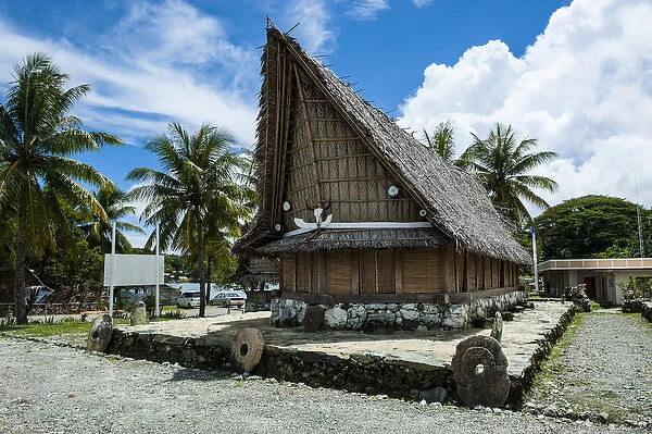 Traditional house with stone money in front, Island of Yap, Micronesia