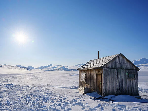 Traditional hut at frozen Gronfjorden, Island of Spitsbergen. Arctic region, Scandinavia, Norway, Svalbard