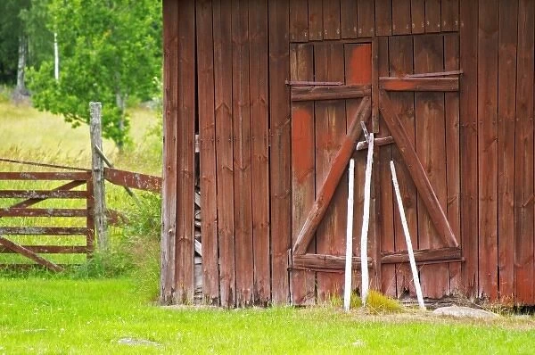 Traditional style Swedish wooden painted house. A door Barn Smaland region. Sweden, Europe