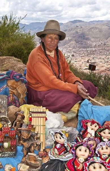 Traditional woman with colorful clothes selling souvenirs in religious region Saqsayhuaman