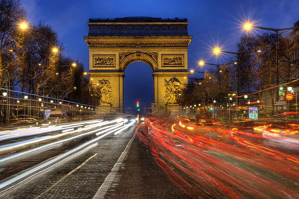Traffic passes the Arch de Triumph on the Champs Elysee in Paris, France